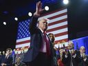 Donald Trump waves as he walks with former first lady Melania Trump at an election night watch party at the Palm Beach Convention Center on Nov. 6, 2024, in West Palm Beach, Fla.