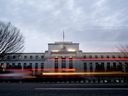 Vehicles drive past the Marriner S. Eccles Federal Reserve building in Washington, D.C.